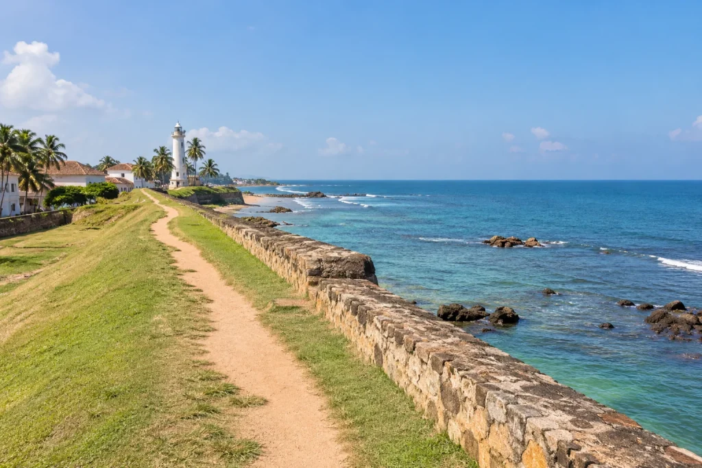 AI-generated stone rampart and coastal walking path overlooking the Indian Ocean, inspired by Galle.